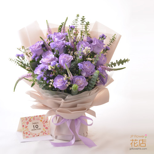 Flowerg Flower's custom purple-themed bouquet with roses, wintersweet, sage, eucalyptus, and forget-me-nots, perfect for graduation and proposals.